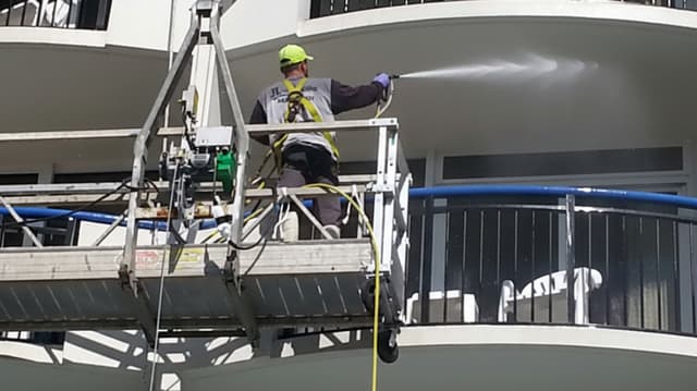 Pressure washing a multi-story apartment complex