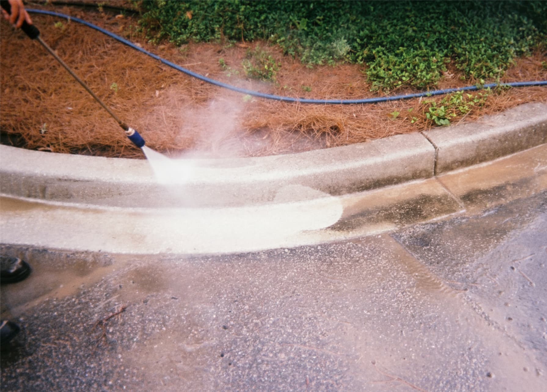 Pressure washing a dirty walkway